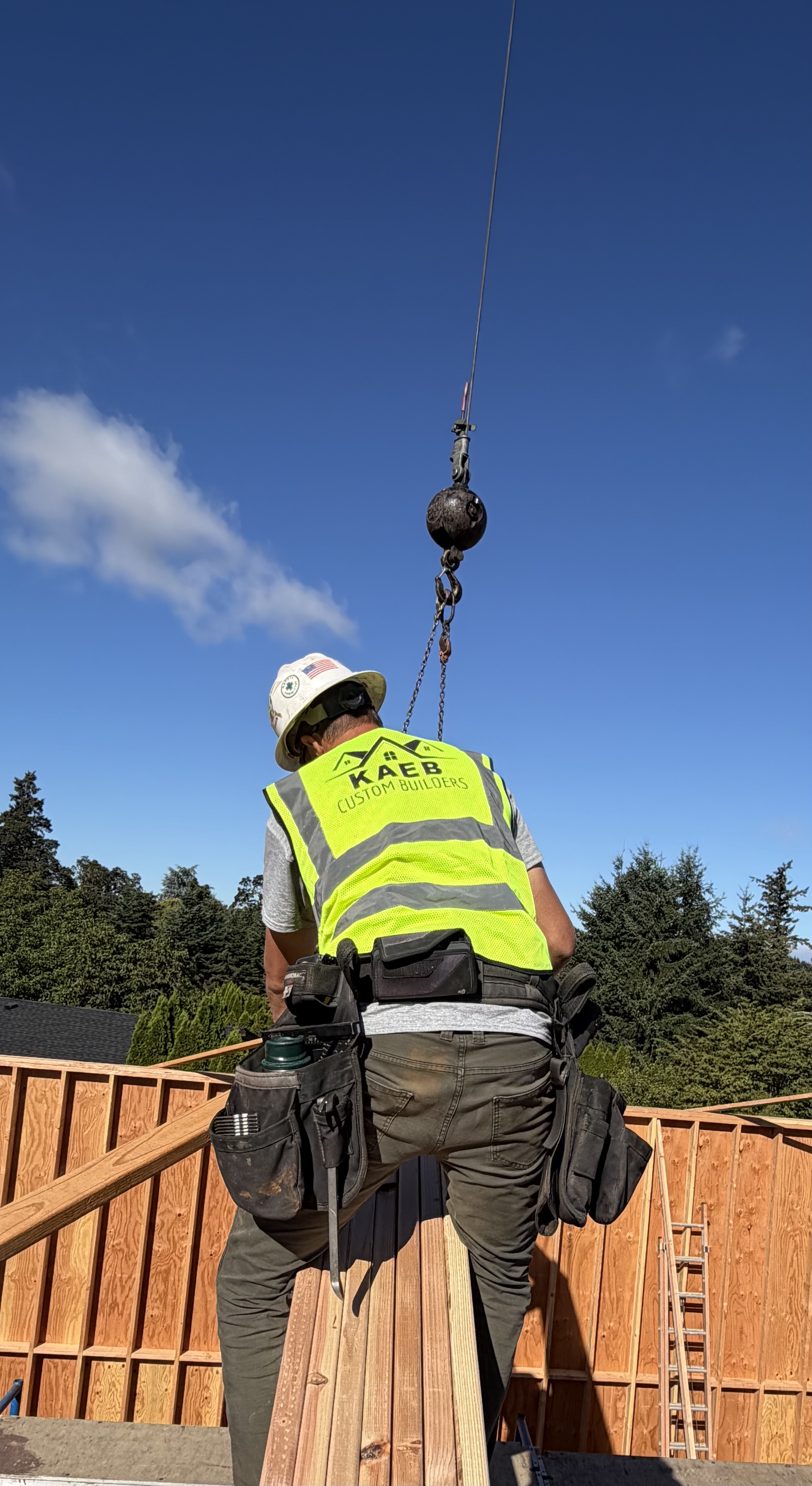 KCB crew member guiding a roof truss into place